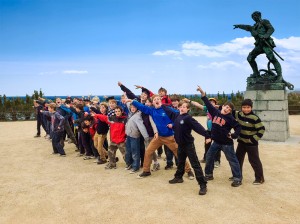 Normandy Experience Excursion students mimicking soldier statue